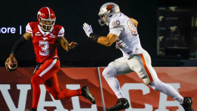B.C. Lions' Mathieu Betts, right, chases down Calgary Stampeders quarterback Vernon Adams Jr. during second half CFL football action in Calgary, Thursday, Aug. 13, 2026. (Jeff McIntosh/CP)