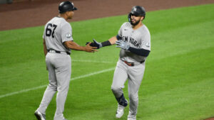 New York Yankees' Luis Garcia Jr., right, celebrates after his solo home run with third base coach Luis Rojas (67) as he rounds the bases during the sixth inning of a baseball game against the Baltimore Orioles, Thursday, Aug. 20, 2026, in Baltimore. (Nick Wass/AP)