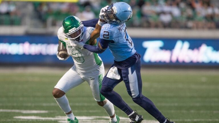 Saskatchewan Roughriders wide receiver KeeSean Johnson (3) pushes away Toronto Argonauts defensive back Tarvarus McFadden (2) during second half CFL football action in Regina on Friday, June 26, 2026. (Kayle Neis/THE CANADIAN PRESS)