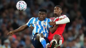 Coventry City's Taiwo Awoniyi fights for the ball with Arsenal's Cristhian Mosquera, right, during the English Premier League soccer match between Arsenal and Coventry City in London, Friday, Aug. 21, 2026. (Kirsty Wigglesworth/AP Photo)