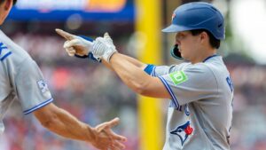 Toronto Blue Jays' Brett Bateman, right, gestures from first base after hitting an RBI single during the fifth inning of a baseball game against the Philadelphia Phillies, Sunday, Aug. 9, 2026, in Philadelphia. (Laurence Kesterson/AP Photo)