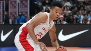 Canada guard Trae Bell-Haynes (25) dribbles past France guard Yakuba Ouattara (24) during the Basketball World Cup group H match between France and Canada at the Indonesia Arena stadium in Jakarta, Indonesia, Friday, Aug. 25, 2023. (Dita Alangkara/AP)