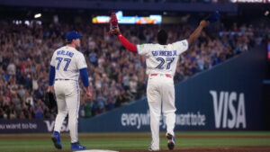 Toronto Blue Jays first baseman Vladimir Guerrero Jr. (27) reacts with teammate Toronto Blue Jays pitcher Louis Varland (77) after defeating the Boston Red Sox during ninth inning American League MLB baseball action in Toronto on Wednesday, August 12, 2026. (Nathan Denette/CP)