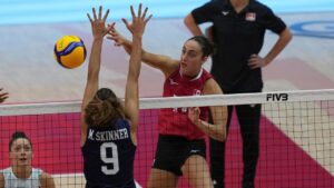 Canada's Andrea Mitrovic, right, spikes the ball against United States' Madisen Skinner, front during the FIVB Women's Volleyball World Championship 2025 second round match between US and Canada at at Indoor stadium Huamark in Bangkok , Thailand, Monday, Sept. 1, 2025. (Sakchai Lalit/AP Photo)