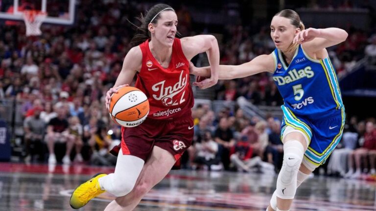 Indiana Fever guard Caitlin Clark, left, drives against Dallas Wings guard Paige Bueckers (5) in the first half of a WNBA basketball game in Indianapolis, Friday, Aug. 14, 2026. (Michael Conroy/AP)