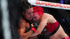 Mackenzie Dern, left, battles Gillian Robertson in a women's strawweight title fight at the UFC 330 mixed martial arts event Saturday, Aug. 15, 2026, in Philadelphia. (Derik Hamilton/AP)