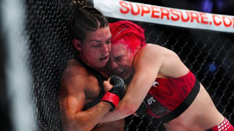 Mackenzie Dern, left, battles Gillian Robertson in a women's strawweight title fight at the UFC 330 mixed martial arts event Saturday, Aug. 15, 2026, in Philadelphia. (Derik Hamilton/AP)