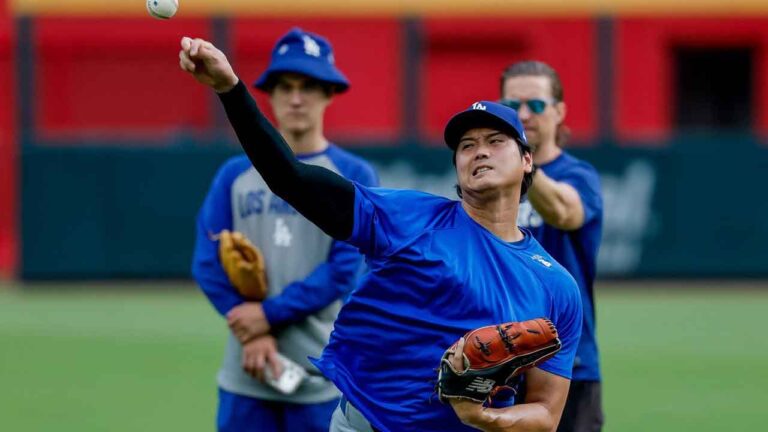 Los Angeles Dodgers pitcher Shohei Ohtani, front, throws a practice session in the outfield before a baseball game. (Erik S. Lesser/AP)