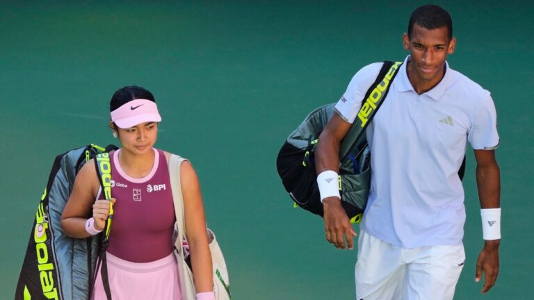 Alexandra Eala, of the Philippines, and Felix Auger-Aliassime, of Canada, enter the court ahead of a mixed doubles match at the U.S. Open tennis championships, Tuesday, Aug. 25, 2026, in New York. (Yuki Iwamura/AP Photo)