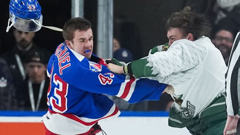 Kitchener Rangers' Andrew MacNiel, left, loses his helmet as he and Everett Silvertips' Jaxsin Vaughan fight during the second period of a Memorial Cup hockey game, in Kelowna, B.C., on Monday, May 25, 2026. (Darryl Dyck/CP)