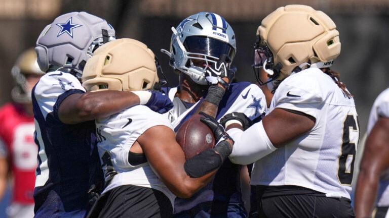 New Orleans Saints running back C.J. Donaldson, second from right, grabs the face mask of Dallas Cowboys outside linebacker Isaiah Land, second from left, during a scrum during an NFL football joint practice, Tuesday, Aug. 18, 2026, in Oxnard, Calif. (Mark J. Terrill/AP)