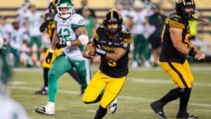 Hamilton Tiger-Cats quarterback Tre Ford (5) runs the ball during second half CFL football action against the Saskatchewan Roughriders in Hamilton, Saturday, Aug. 15, 2026. (Nick Iwanyshyn/THE CANADIAN PRESS)
