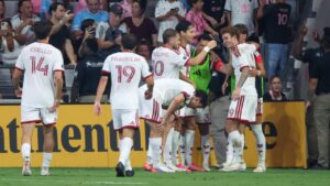 Toronto FC forward Josh Sargent (9) celebrates with teammates after scoring during the second half of an MLS soccer game against Inter Miami on Saturday, Aug. 22, 2026, in Miami. (AP Photo/David Santiago)