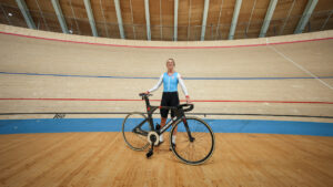 Track cyclist Kelsey Mitchell laughs while posing for a photograph before training at the Alberta Velodrome, in Edmonton, on Wednesday, August 19, 2026. (Darryl Dyck/CP)