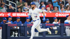 Toronto Blue Jays' Nathan Lukes (38) comes in to score on an RBI double by Brett Bateman (21) during third inning MLB baseball action against the Boston Red Sox in Toronto, on Tuesday, Aug. 11, 2026. (Sammy Kogan/CP)