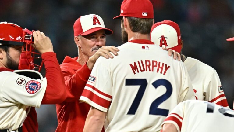 Los Angeles Angels pitcher Luke Murphy (72) speaks with pitching coach Mike Maddux, second from left, during the eighth inning of a baseball game against the Milwaukee Brewers, Friday, July 31, 2026, in Anaheim, Calif. (William Liang/AP)