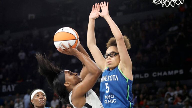 Las Vegas Aces guard Jackie Young shoots against Minnesota Lynx guard Olivia Miles (5) during the first half of a WNBA basketball game Saturday, Aug. 15, 2026, in Las Vegas. (Steve Marcus/Las Vegas Sun via AP)