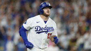 Los Angeles Dodgers' Max Muncy (13) watches the ball after hitting a walk-off RBI single during the tenth inning of a baseball game against the Kansas City Royals, Tuesday, Aug. 11, 2026, in Los Angeles. (Caroline Brehman/AP)