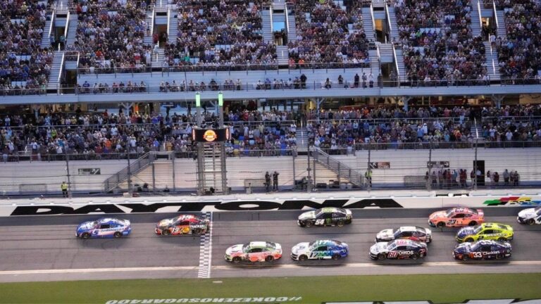 Kyle Larson (5) and Chase Briscoe (19) lead a group through the front stretch during early laps in the NASCAR auto race at Daytona International Speedway, Saturday, Aug. 29, 2026, in Daytona Beach, Fla. (John Raoux/AP)