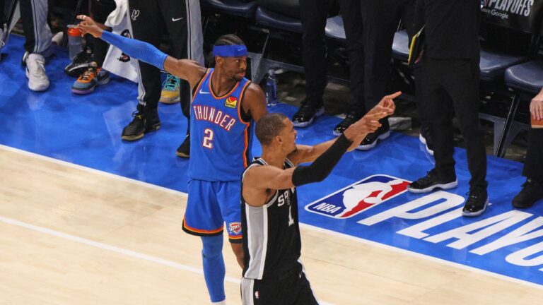 San Antonio Spurs forward Victor Wembanyama (1) and Oklahoma City Thunder guard Shai Gilgeous-Alexander (2) both appeal for possession in the second half of Game 7 of the Western Conference finals of the NBA basketball playoffs series Saturday, May 30, 2026, in Oklahoma City. (Nate Billings/AP)