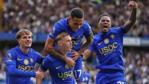 Chelsea's Cole Palmer, centre, celebrates with teammates after scoring his side's fourth goal during the English Premier League soccer match between Chelsea and Brighton and Hove Albion in London, Sunday, Aug. 30, 2026. (Ian Walton/AP)