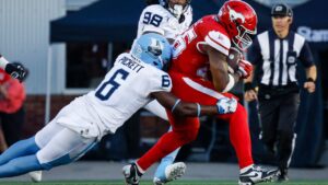 Toronto Argonauts' Adarius Pickett (6) tackles Calgary Stampeders' Dedrick Mills during second half CFL football action in Calgary, Thursday, July 2, 2026. (Jeff McIntosh/THE CANADIAN PRESS)