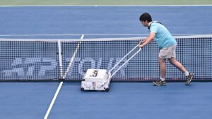 A ground crew member dries centre court during a rain delay at the National Bank Open tennis tournament in Montreal, on Sunday, Aug. 2, 2026. (Graham Hughes/THE CANADIAN PRESS)