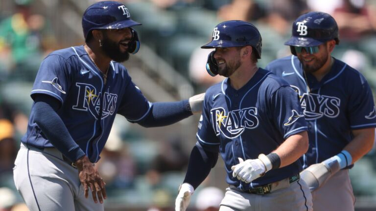 Tampa Bay Rays' Liam Hicks, middle, is congratulated by teammate Junior Caminero, left, after hitting a three-run home run during the fourth inning of a baseball game against the Athletics Wednesday, Aug. 12, 2026, in West Sacramento, Calif. (Scott Marshall/AP Photo)