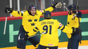 Sweden's Leo Carlsson (91) celebrates after scoring a goal with Mika Zibanejad, left, and Marcus Johansson during the second period of a quarterfinal match at the ice hockey world championships against the Czech Republic in Stockholm, Sweden, Thursday, May 22, 2025. (Petr David Josek/AP)