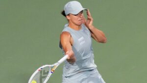 Poland's Iga Swiatek hits a return to Ukraine's Elina Svitolina during National Bank Open semi final tennis action in Toronto on Wednesday, August 12, 2026. (Chris Young/THE CANADIAN PRESS)
