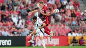 Toronto FC defender Walker Zimmerman (25) gets the header over New England Revolution forward Dor Turgeman (99) during first half MLS soccer action in Toronto, Saturday, Aug. 15, 2026. (Nathan Denette/CP)
