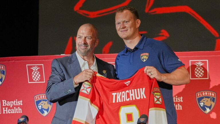 Florida Panthers general manager Bill Zito, left, and Brady Tkachuk holds his jersey as the new member of the team Tuesday, June 23, 2026, in Fort Lauderdale, Fla. (Marta Lavandier/AP Photo)