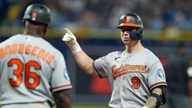Baltimore Orioles' Tyler O'Neill (9) celebrates with first base coach Jason Bourgeois (36) after his RBI single off Tampa Bay Rays pitcher Bryan Baker during the 10th inning of a baseball game Saturday, Aug. 15, 2026, in St. Petersburg, Fla. (Chris O'Meara/AP)