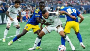 Houston Dynamo FC's Guilherme Santos, centre, Vancouver Whitecaps' Cheick Sabaly, left, and Andres Cubas, right, vie for the ball during the first half of an MLS soccer match in Vancouver, B.C., on Wednesday, August 19, 2026. (Ethan Cairns/THE CANADIAN PRESS)