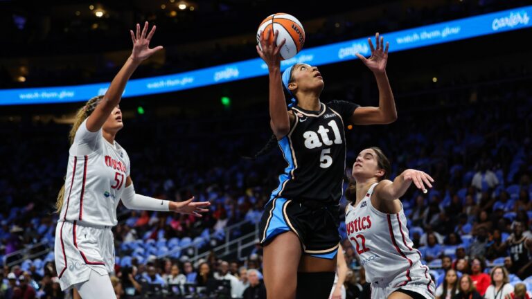 Atlanta Dream forward Angel Reese (5) looks to shoot against Washington Mystics center Lauren Betts, left, and guard Sonia Citron, right, during the first half in Game 1 of an WNBA basketball first-round playoff series, Sunday, Sept. 27, 2026, in Atlanta. (Colin Hubbard/AP)