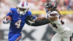 Buffalo Bills running back James Cook III (4) is tackled by Houston Texans cornerback Derek Stingley Jr., right, during the first half of an NFL football game, Sunday, Sept. 13, 2026, in Houston. (AP Photo/Ashley Landis)