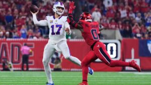 Buffalo Bills quarterback Josh Allen (17) throws a pass under pressure from Houston Texans linebacker Azeez Al-Shaair (0) in the first half of an NFL football game Thursday, Nov. 20, 2025, in Houston. (AP Photo/Ashley Landis)