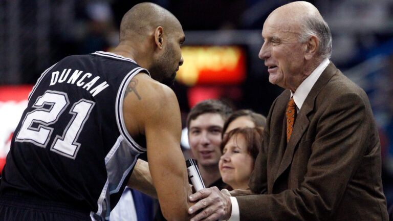 San Antonio Spurs power forward Tim Duncan (21) shakes hands with former NBA player Bob Pettit before the start of the Spurs New Orleans Hornets NBA basketball game in New Orleans, Monday, Jan. 7, 2013. (AP Photo/Bill Haber)