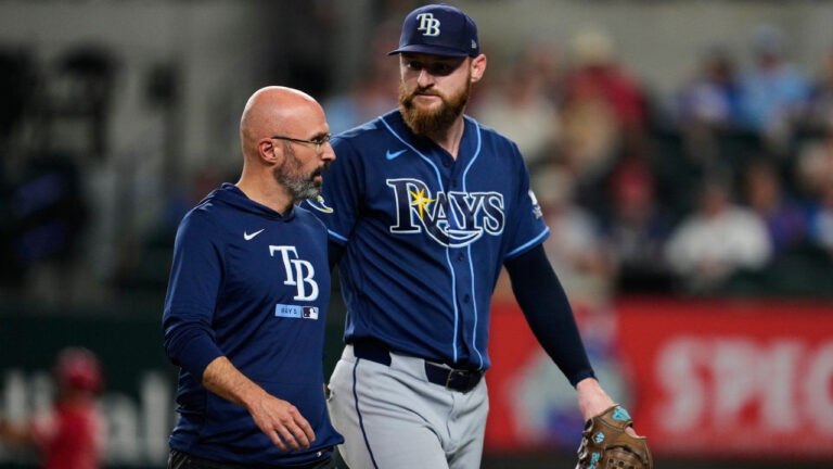 Tampa Bay Rays pitcher Bryan Baker, right, walks off the field with a member of the staff after throwing to the Texas Rangers during the ninth inning of a baseball game Friday, Sept. 4, 2026, in Arlington, Texas. (Tony Gutierrez/AP)