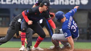 Texas Rangers left fielder Wyatt Langford (36) slides into second base with a steal ahead of a tag by Toronto Blue Jays infielder Ernie Clement (22) during first inning MLB baseball action in Toronto on Friday June 26, 2026. (Jon Blacker/CP)