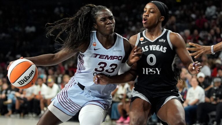 Toronto Tempo guard Ornella Bankole (33) drives into Las Vegas Aces guard Jackie Young (0) during the first half of a WNBA basketball game Friday, Aug. 28, 2026, in Las Vegas. (AP Photo/John Locher)
