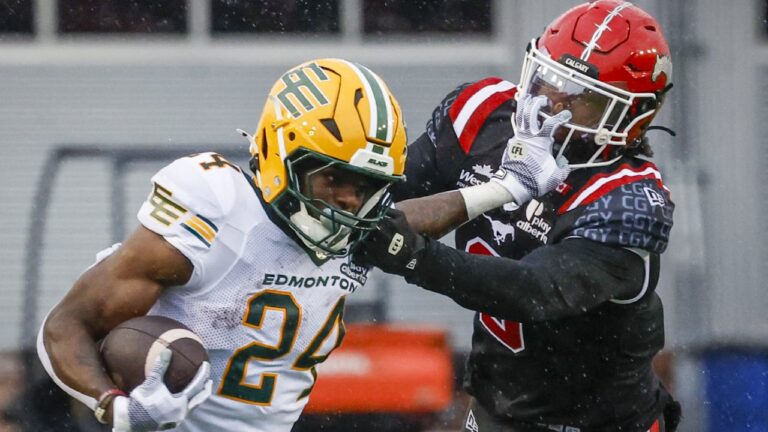 Edmonton Elks' ShunDerrick Powell, left, holds off Calgary Stampeders' Damon Webb during second half CFL football action in Calgary, Monday, Sept. 7, 2026. THE CANADIAN PRESS/Jeff McIntosh