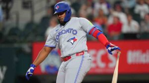Toronto Blue Jays' Vladimir Guerrero Jr. reacts after striking out swinging against Texas Rangers starting pitcher Kumar Rocker during the first inning of a baseball game Friday, Sept. 18, 2026, in Arlington, Texas. (Julio Cortez/AP)