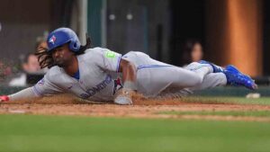Toronto Blue Jays Charles McAdoo slides scoring on a single by Andres Gimenez during the seventh inning of a baseball game against the Texas Rangers, Sunday, Sept. 20, 2026, in Arlington, Texas. (LM Otero/AP)