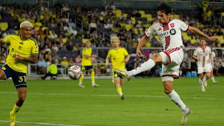 Toronto FC forward Daniel Salloi, right, kicks the ball against Nashville SC defender Andy Najar (31) during the first half of an MLS soccer match Saturday, Sept. 26, 2026, in Nashville, Tenn. (AP Photo/George Walker IV)