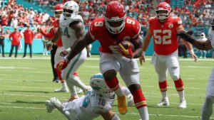 Kansas City Chiefs running back Kenneth Walker III (9) scores a touchdown against Miami Dolphins safety Michael Taaffe during an NFL football game, Sunday, Sept. 27, 2026, in Miami Gardens. (David Santiago/AP)