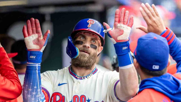 Philadelphia Phillies' Bryce Harper is cheered in the dugout after hitting a solo home run in the fifth inning of a baseball game against the Tampa Bay Rays, Sunday, Sept. 27, 2026, in Philadelphia. (Laurence Kesterson/AP)