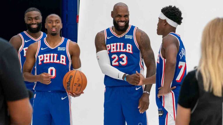 Philadelphia 76ers' LeBron James, center right, greats VJ Edgecombe, right, as they get ready for a group photos with Tyrese Maxey, center left, and Jaylen Brown, left, during the NBA basketball team's media day, Monday, Sept. 28, 2026, in Camden, N.J.. (Chris Szagola/AP)