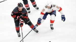 Carolina Hurricanes right wing Andrei Svechnikov (37) and Florida Panthers center Aleksander Barkov (16) vie for the puck during the second period in Game 5 of the NHL hockey Stanley Cup Eastern Conference finals Wednesday, May 28, 2025, in Raleigh, N.C. (Chris Seward/AP)