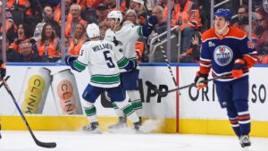 Vancouver Canucks' Tom Willander (5) and Paul Cotter (47) celebrate Cotter's game-winning goal against the Edmonton Oilers during overtime NHL hockey action in Edmonton on Tuesday, Sept. 29, 2026. (Codie McLachlan/CP)